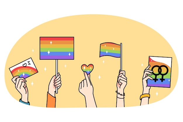 As mãos das pessoas seguram bandeiras LGBT