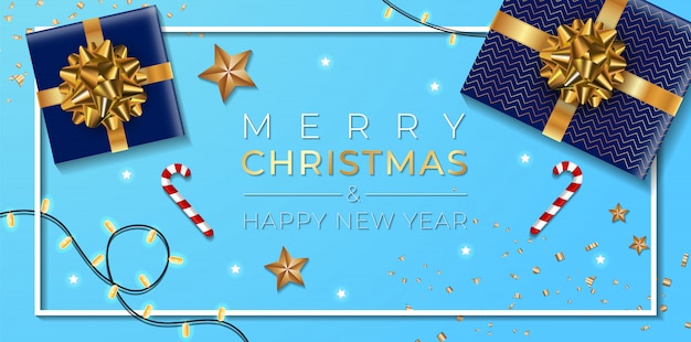 Banner de natal. projeto de natal de fundo da guirlanda de luzes brilhantes, com caixa de presentes realista, estrelas douradas e confetes de ouro glitter. mesa azul.