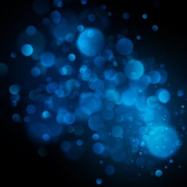 Bokeh azul circular defocused abstrato no fundo escuro.