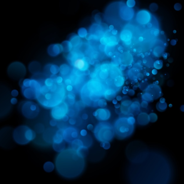 Bokeh azul circular defocused abstrato no fundo escuro.