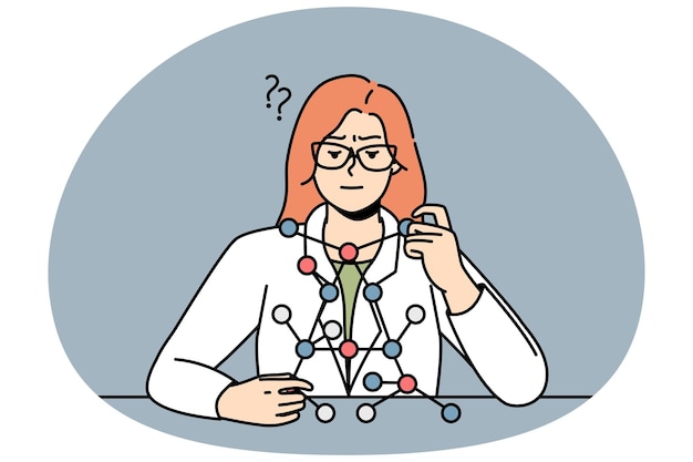 Cientista sentada à secretária olha para o modelo de molécula