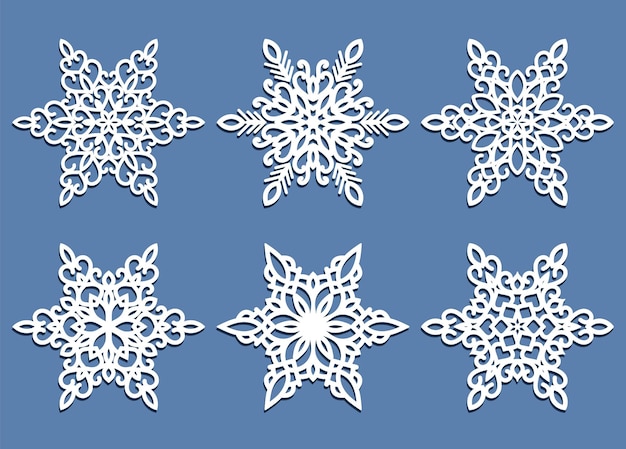 conjunto de flocos de neve de corte a laser isolados em azul