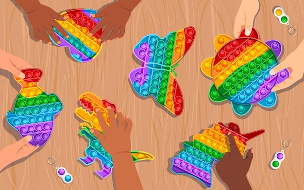 Vetor crianças brincando com popits de arco-íris coloridos em forma de peixe-coração dinossauro sol borboleta e unicórnio covinha simples na mesa de madeira ao fundo ilustração gráfica vetorial