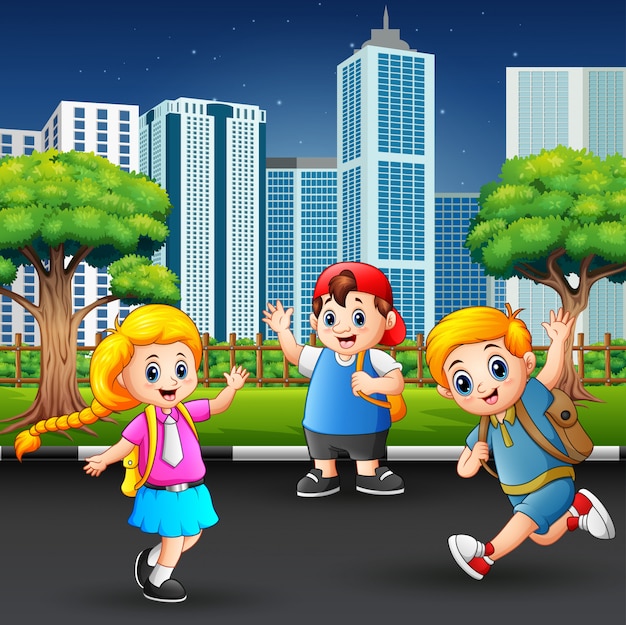 Crianças de escola felizes andando na estrada da cidade