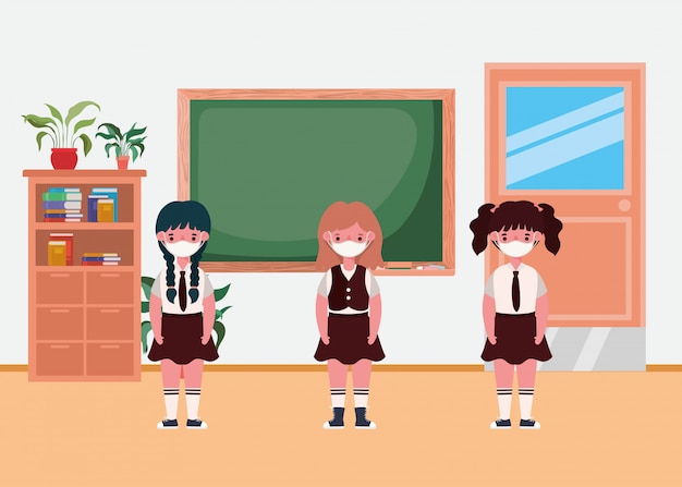 Crianças de meninas com máscaras na sala de aula