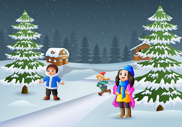 Crianças felizes a usar roupas de inverno e jogar em um ambiente de aldeia