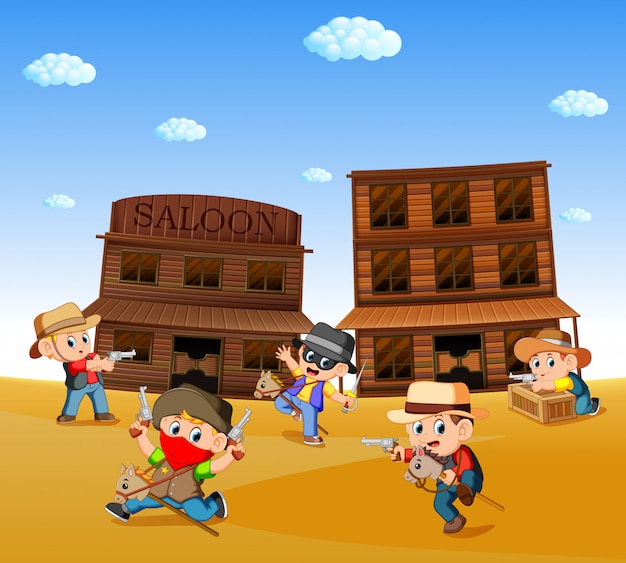 Crianças vestindo fantasia de cowboy e brincar com o fundo da cidade ocidental