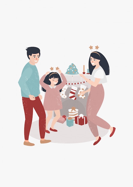 família dançando perto da lareira no dia de Natal