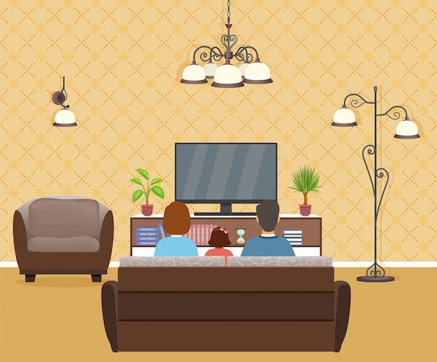 Família de homem, mulher e criança assistindo tv no interior da sala de estar.