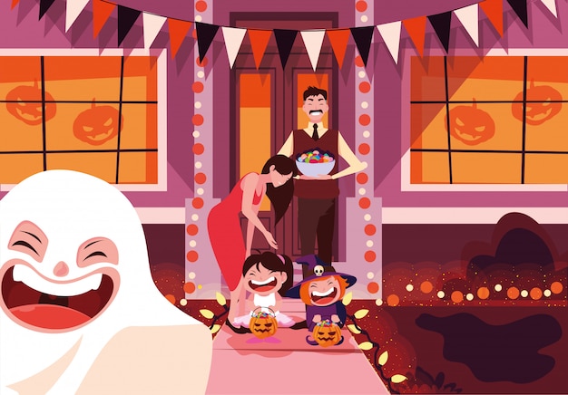 Família feliz com doces na celebração da noite de halloween
