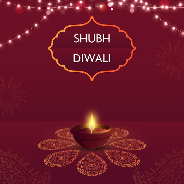 Fonte shubh happy diwali em moldura vintage com lâmpada de óleo iluminada diya e guirlanda de iluminação sobre fundo vermelho paisley