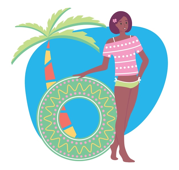 Garota fica perto de uma palmeira e mantém um círculo de natação