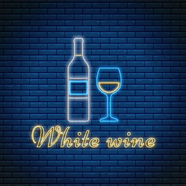 Garrafa de vinho branco e copo com letras em estilo neon em fundo de tijolo.