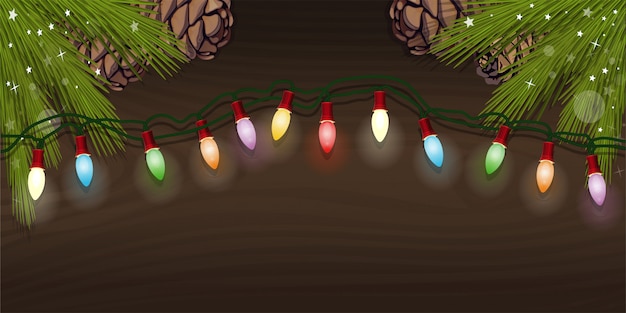 Guirlanda de árvore de natal elétrica com lâmpadas multicoloridas para o projeto de natal. guirlanda elétrica brilhante e ramos de abeto com cones de abeto em um fundo de madeira.