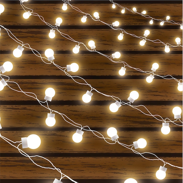 Vetor luzes de natal isoladas em fundo escuro de madeira glow garland vector brilham lâmpadas de natal em fios