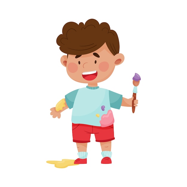 Menino alegre em roupas manchadas carregando pincel e ilustração vetorial de pintura
