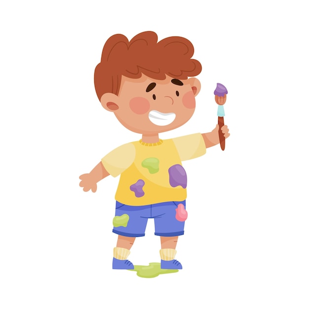 Menino alegre em roupas manchadas carregando pincel e ilustração vetorial de pintura