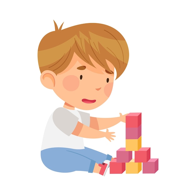 Menino excitado sentado no chão na creche jogando blocos de brinquedo ilustração vetorial