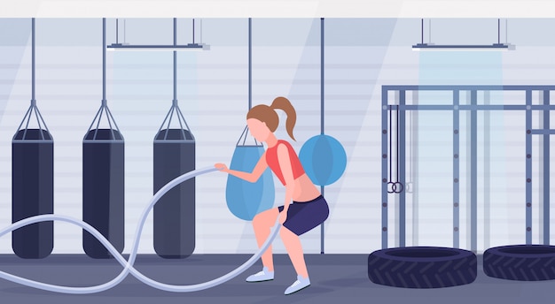 mulher desportivo fazendo crossfit exercícios com treino de corda menina treinamento gym gym workout moderno boxe clube saudável interior lifestyle estilo de vida saudável conceito comprimento total horizontal