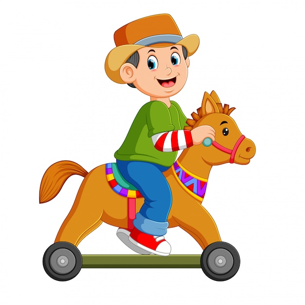 O menino está jogando no brinquedo de cavalo com as rodas