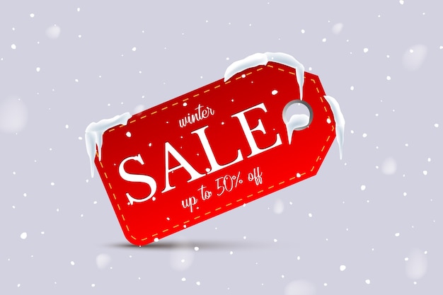 Texto de venda de inverno na etiqueta vermelha em fundo de neve.