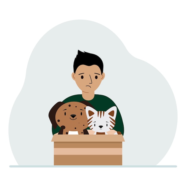 Um garotinho segura uma caixa de papelão com um gato e um cachorro O conceito de ajuda de resgate e cuidados com animais de estimação