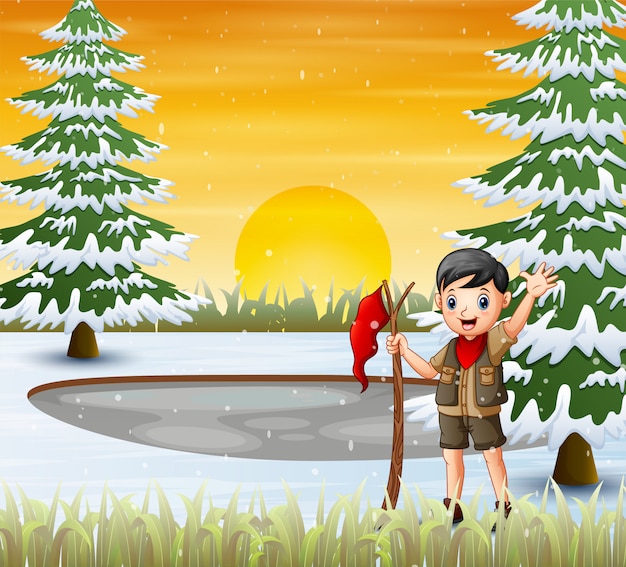 Um garoto escoteiro com bandeira vermelha na paisagem de inverno