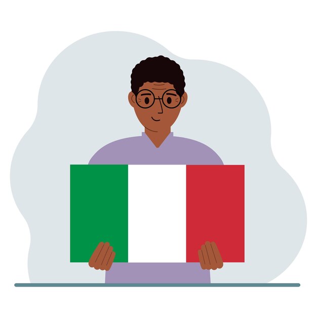 Um homem segura uma bandeira italiana em suas mãos o conceito de feriado nacional de demonstração ou patriotismo