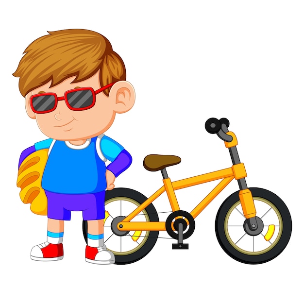 Um menino de pé na bicicleta