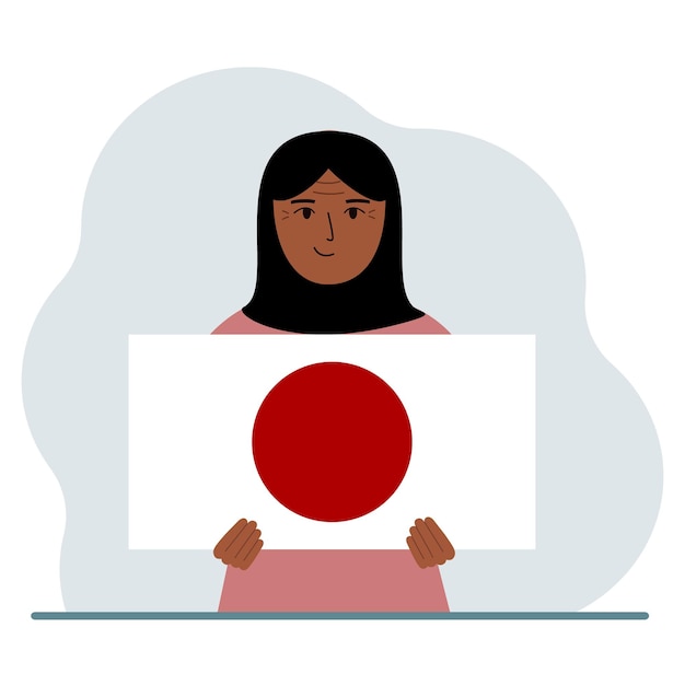 Uma mulher segura a bandeira do japão em suas mãos o conceito de feriado nacional de demonstração ou patriotismo nacionalidade