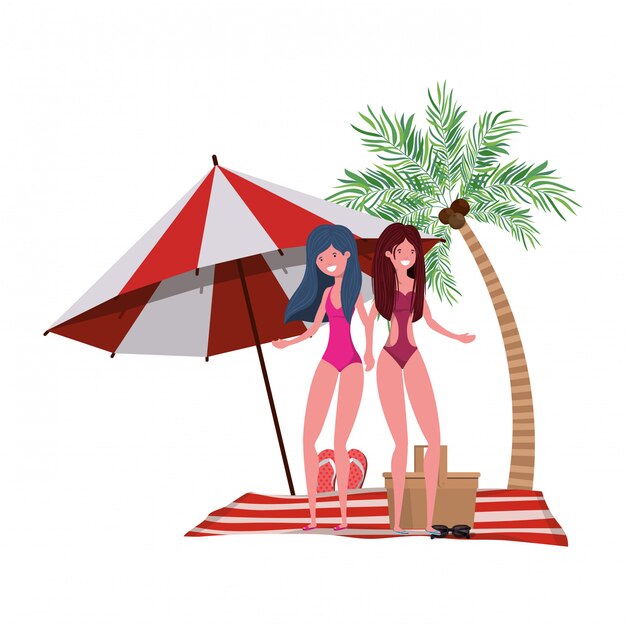 Donne con costume da bagno sulla spiaggia e ombrellone