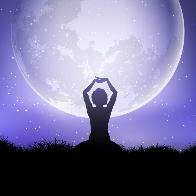 Femmina in posa yoga contro un cielo illuminato dalla luna