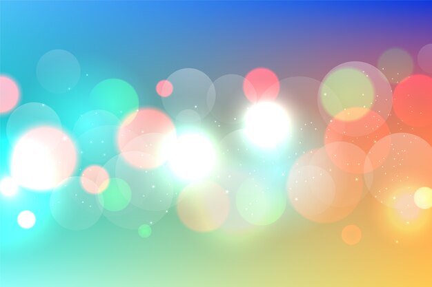 Sfondo colorato bokeh con particelle luccicanti
