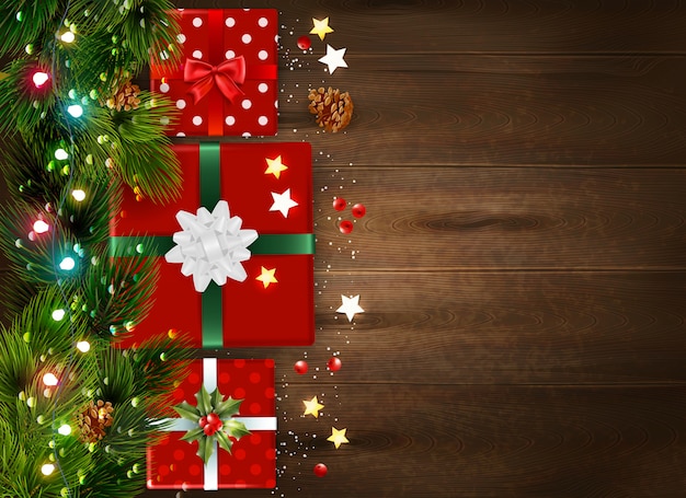 Sfondo di Natale con rami di abete e contenitori di regalo decorati su superficie di legno realistico
