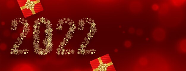 Striscione rosso del nuovo anno 2022 realizzato con fiocchi di neve dorati con confezione regalo