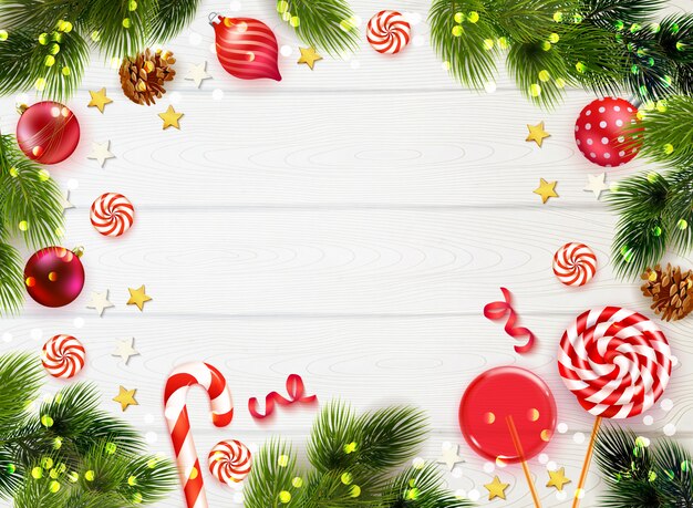 Tavolo in legno realistico sfondo incorniciato con rami di abete caramelle e decorazioni natalizie