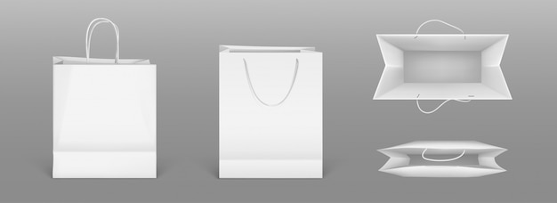 Vista frontale e superiore dei sacchetti della spesa del Libro Bianco. modello realistico di pacchetto vuoto con maniglie isolato su sfondo grigio. Modello per la progettazione aziendale sul sacchetto di cartone per negozio o mercato