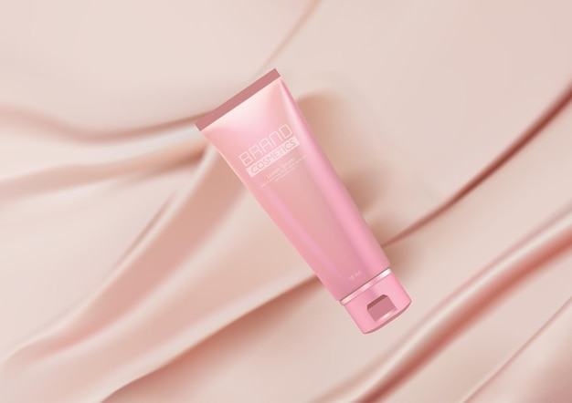 Annunci cosmetici di lusso prodotto cosmetico mock up su sfondo rosa in tessuto di seta piegato Tubo cosmetico