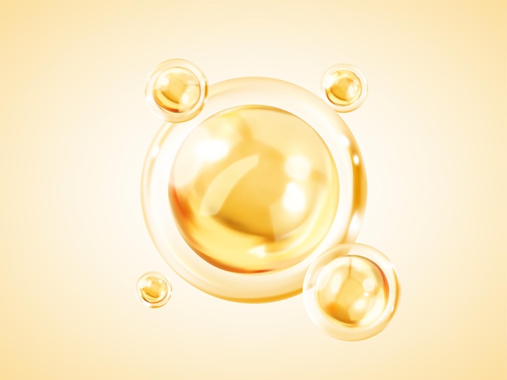 Bubble liquide dorate trasparenti Bubble di olio o siero giallo dorato isolato su sfondo giallo