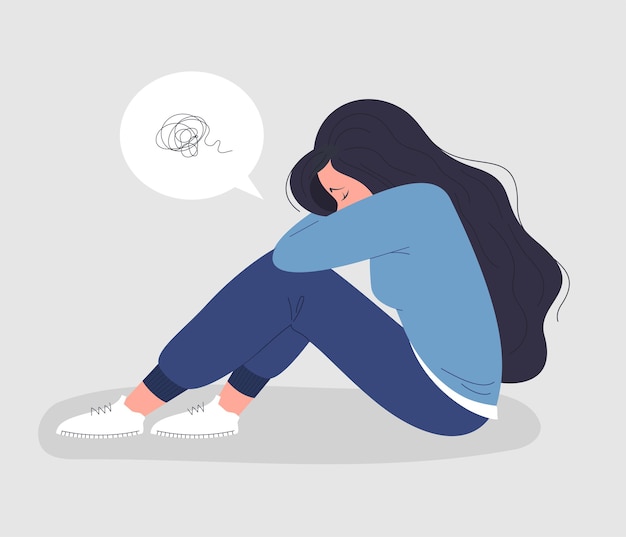 Donna depressa seduta a testa bassa
