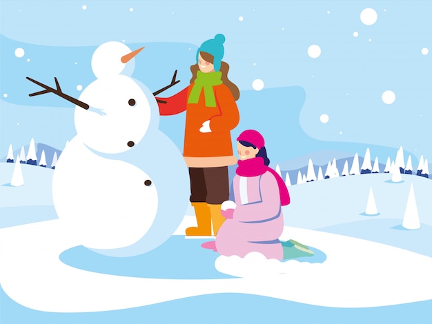 Donne con pupazzo di neve nel paesaggio invernale