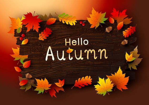 Foglie di autunno su fondo di legno marrone