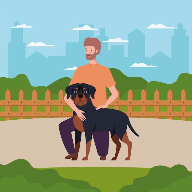 Giovane con simpatico cane mascotte nel campo