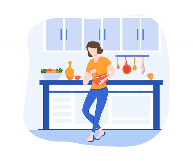 Giovane donna che cucina nella cucina. Prepara cibi sani. Cucinare A Casa.