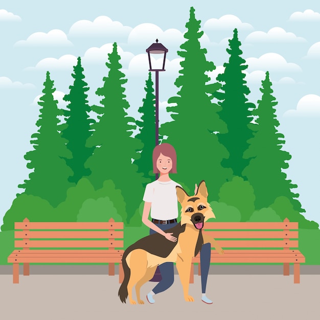 Giovane donna con la mascotte cane carino nel parco