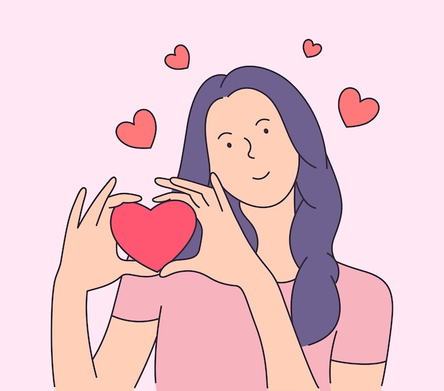 Giovane donna sorridente che tiene grande cuore rosso.