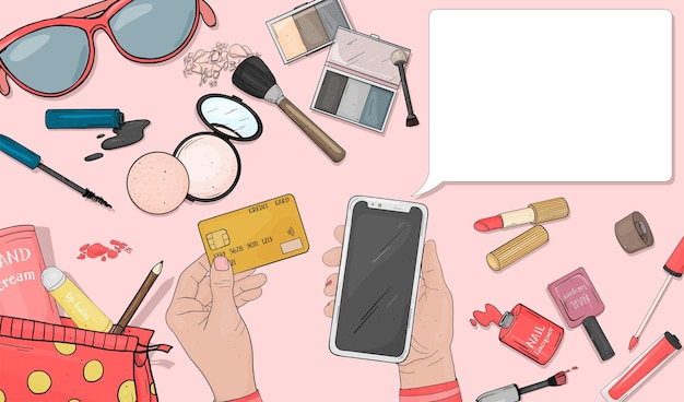 Le mani delle donne usano una carta di credito e uno smartphone per pagare i cosmetici acquistati online