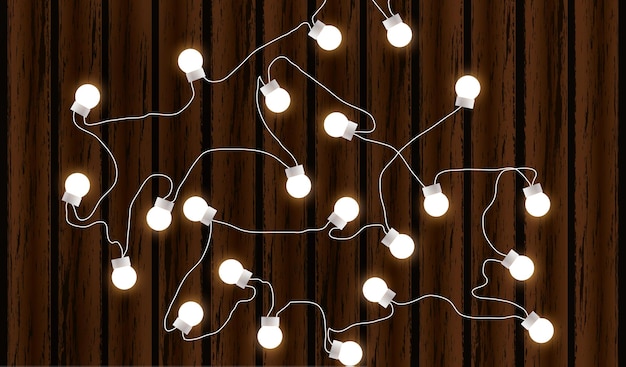 Luci di Natale isolate su sfondo di legno scuro Ghirlanda di bagliore Lampadine di Natale bagliore vettoriali su fili