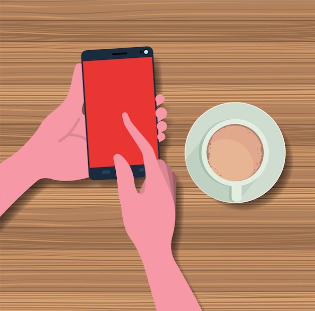 mani utilizzando smartphone con tazza di caffè sul tavolo