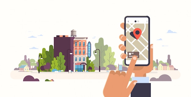 mano che tiene smartphone concetto di prenotazione hotel ostello edificio esterno mobile app gps ricerca punto sulla mappa della città paesaggio urbano